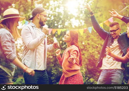 leisure, holidays, fun and people concept - happy friends dancing at summer party in garden. happy friends dancing at summer party in garden