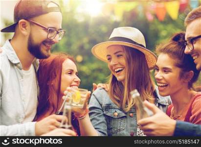 leisure, holidays, people, reunion and celebration concept - happy friends clinking glasses and celebrating at summer garden party. happy friends clinking glasses at summer garden