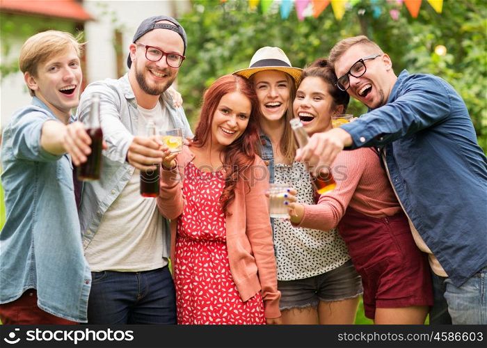 leisure, holidays, people, reunion and celebration concept - happy friends with drinks at summer garden party