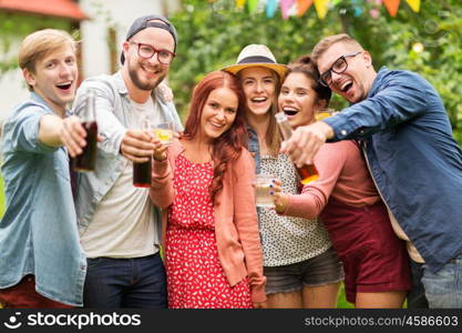 leisure, holidays, people, reunion and celebration concept - happy friends with drinks at summer garden party