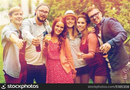 leisure, holidays, people, reunion and celebration concept - happy friends with drinks at summer garden party. happy friends with drinks at summer garden party