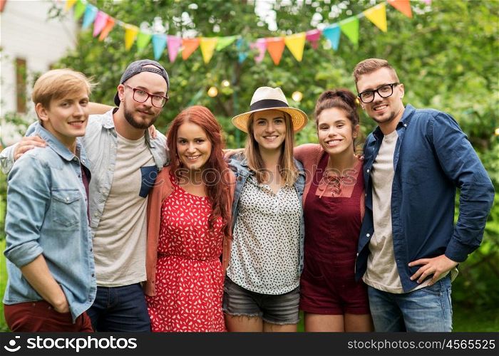 leisure, holidays, reunion, people and friendship concept - happy teenage friends hugging at summer garden party