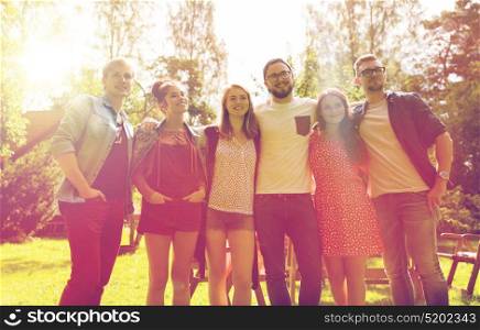 leisure, holidays, reunion, people and friendship concept - happy teenage friends hugging at summer garden party. happy teenage friends hugging at summer garden