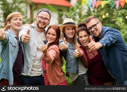 leisure, holidays, reunion, people and friendship concept - happy teenage friends showing thumbs up at summer garden party