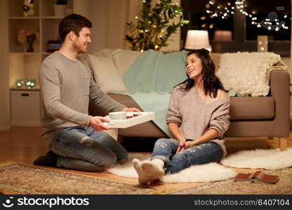 leisure, hygge and people concept - happy couple with food on tray at home. happy couple with food on tray at home