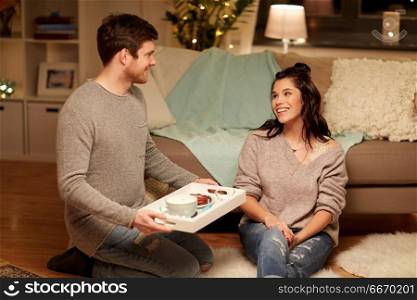 leisure, hygge and people concept - happy couple with food on tray at home. happy couple with food on tray at home. happy couple with food on tray at home