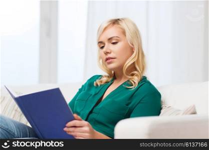 leisure, literature, education and people concept - woman reading book at home