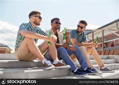 leisure, male friendship and people concept - happy men or friends drinking beer and talking on street in summer. happy male friends drinking beer on street