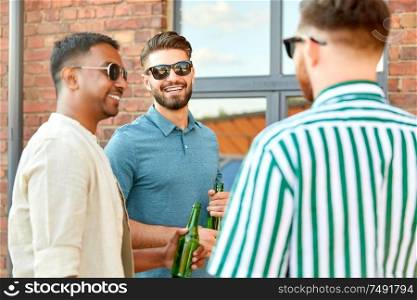 leisure, male friendship and people concept - happy men or friends drinking beer and talking in summer city. happy male friends drinking beer in summer city