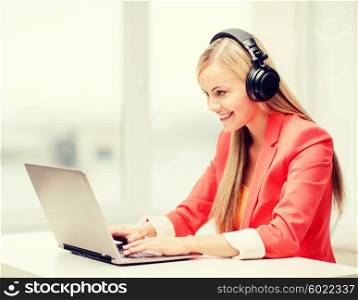 leisure, music, free time, online and internet concept - happy woman with headphones listening to music