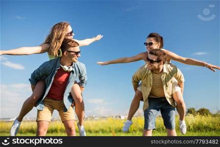 leisure, people and friendship concept - happy teenage friends having fun outdoors in summer. happy teenage friends having fun in summer