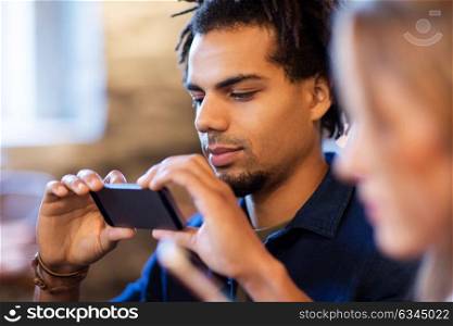 leisure, people and technology concept - close up of happy young man with smartphone. close up of man with smartphone