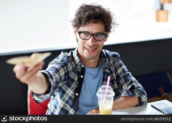 leisure, people, payment and finance concept - happy man with cash money paying at cafe