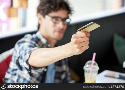 leisure, people, payment and finance concept - man paying with credit card at cafe