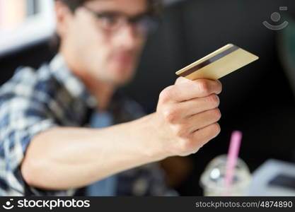 leisure, people, payment and finance concept - man paying with credit card at cafe