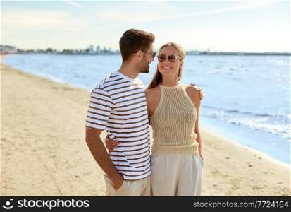 leisure, relationships and people concept - happy couple in sunglasses on summer beach. happy couple on summer beach