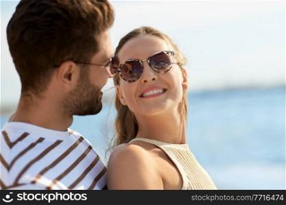 leisure, relationships and people concept - portrait of happy couple on summer beach. portrait of happy couple on summer beach