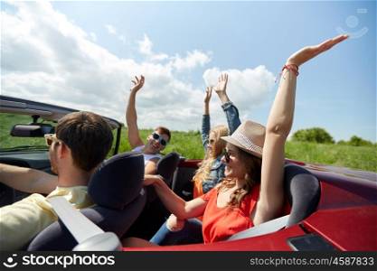 leisure, road trip, travel and people concept - happy friends driving in cabriolet car at country and having fun