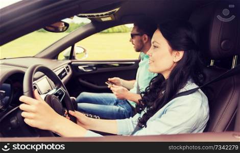 leisure, road trip, travel and people concept - happy man and woman driving in car. happy man and woman driving in car