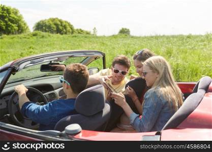 leisure, road trip, travel, technology and people concept - happy friends with tablet pc computer driving in cabriolet car along country road