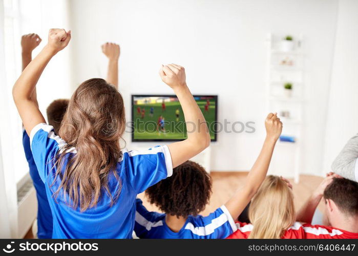 leisure, sport and entertainment concept - happy friends or football fans watching soccer game on tv and celebrating victory at home. friends or soccer fans watching game on tv at home