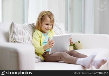 leisure, technology and children concept - little girl with tablet computer at home
