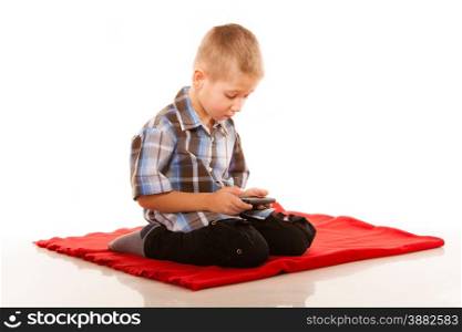 Leisure, technology and internet concept - little boy with smartphone playing games or reading text message