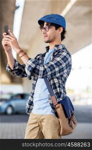 leisure, technology and people concept - hipster man taking selfie picture by smartphone on street