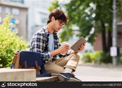 leisure, technology, communication and people concept - creative man with tablet pc computer sitting on city street bench