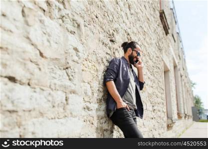 leisure, technology, communication and people concept - smiling man calling on smartphone on street