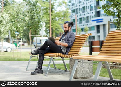 leisure, technology, communication, travel and people concept - man with tablet pc computer sitting on city street bench