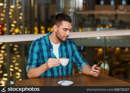 leisure, technology, lifestyle and people concept - man with smartphone and coffee at restaurant