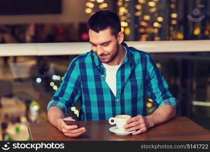 leisure, technology, lifestyle and people concept - smiling man with smartphone and coffee at restaurant. happy man with smartphone and coffee at restaurant