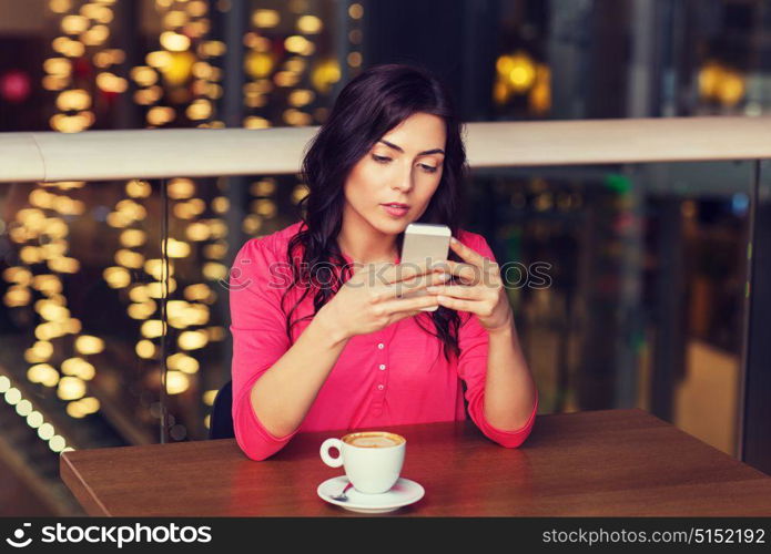 leisure, technology, lifestyle and people concept - woman with smartphone and coffee at restaurant. woman with smartphone and coffee at restaurant