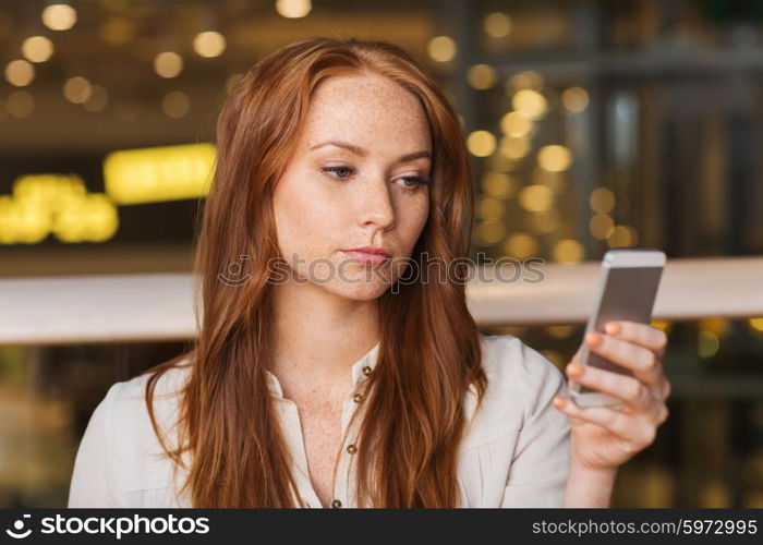 leisure, technology, lifestyle and people concept - woman with smartphone and coffee at restaurant