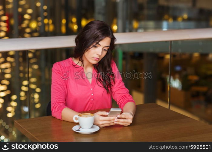 leisure, technology, lifestyle and people concept - woman with smartphone and coffee at restaurant. woman with smartphone and coffee at restaurant