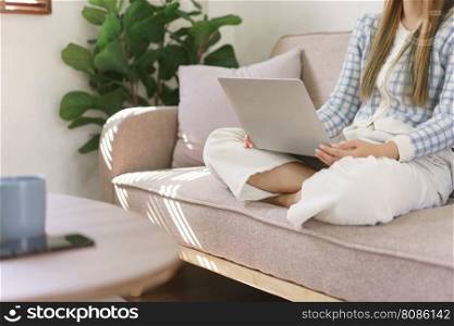 Leisure time concept, Women sitting on comfortable couch and wearing headphone to watching movie.