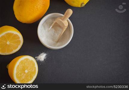 Lemon and baking soda on black background