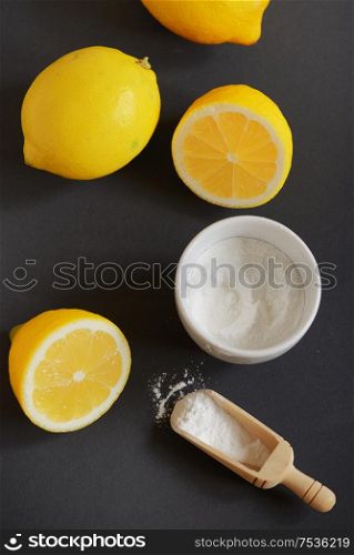 Lemon and baking soda on black background