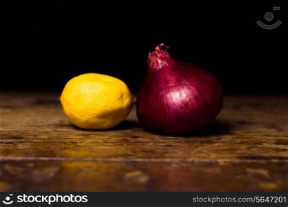 Lemon and onion on wooden surface