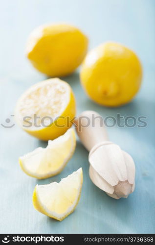 lemon and squeezer over blue background