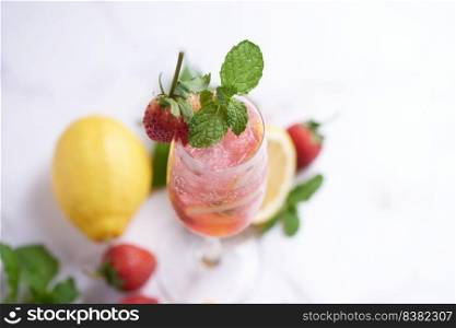 Lemon and strawberry lemonade mint fresh homemade in glass, Summer cold cocktail, Strawberry lemon lime mojito, light background, copy space, A refreshing summer drink concept.
