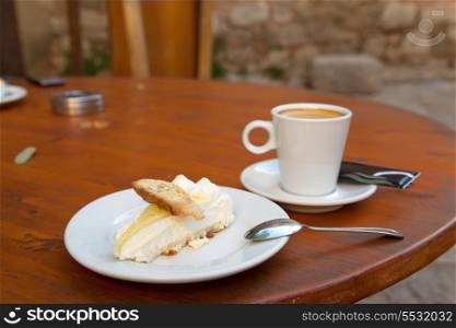 Lemon cake with hazelnut cookie and cup of coffee&#xA;