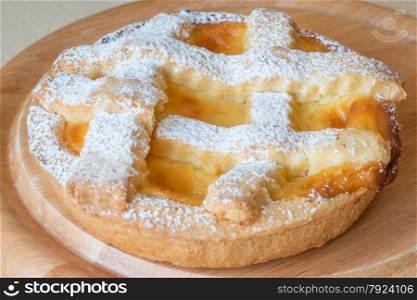 lemon citrus tart dessert on wooden plate
