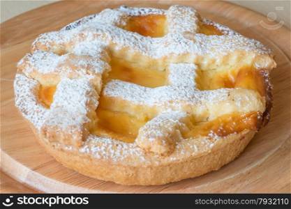 lemon citrus tart dessert on wooden plate
