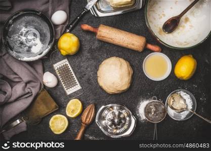 Lemon Cookie or cake Dough with cooking ingredients and bake tools on dark rustic background , top view, flat lay