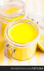 Lemon curd in glass jars on the table