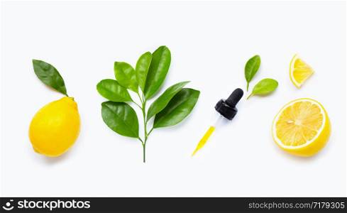 Lemon essential oil and lemon fruits on white background.