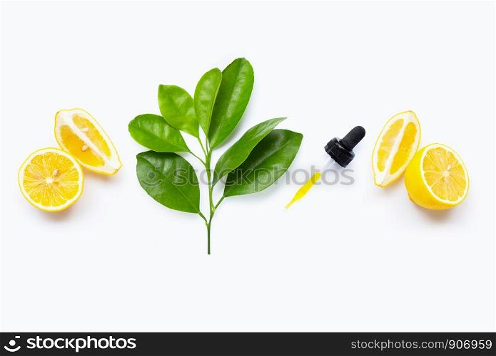 Lemon essential oil and lemon fruits on white background.