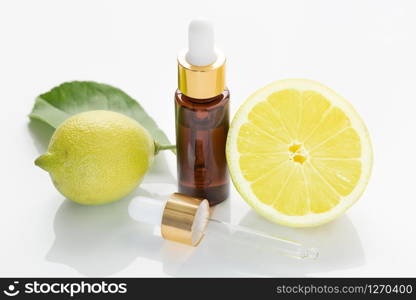 Lemon essential oil isolated on white background. Citrus oil